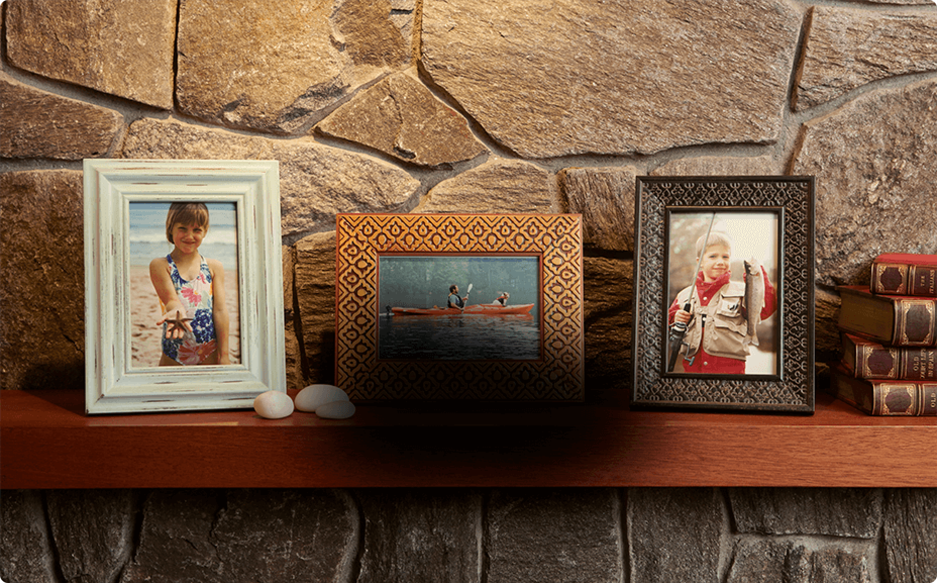 framed pictures on a mantel with black spot blocking view